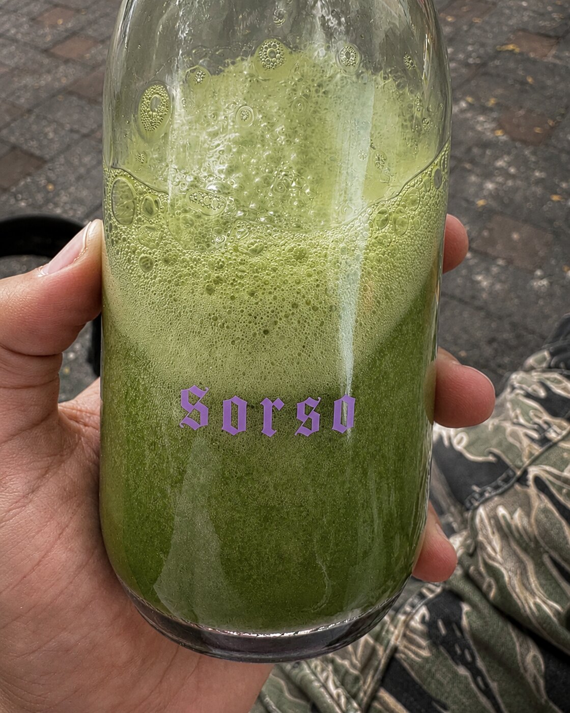 SORSO green juice, violet wordmark on glass
