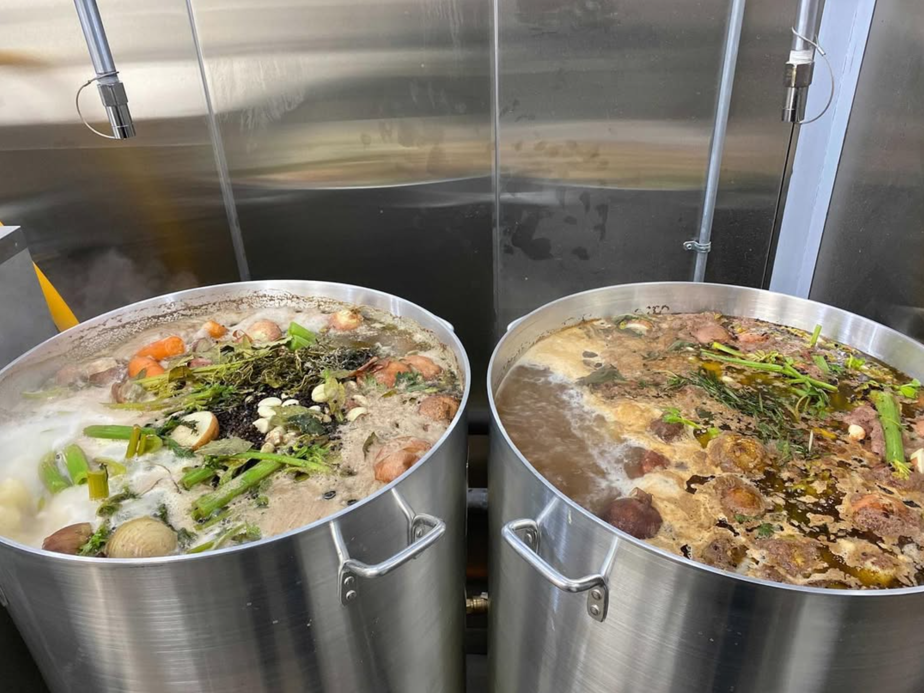 Two stainless pots of slow-simmered broth